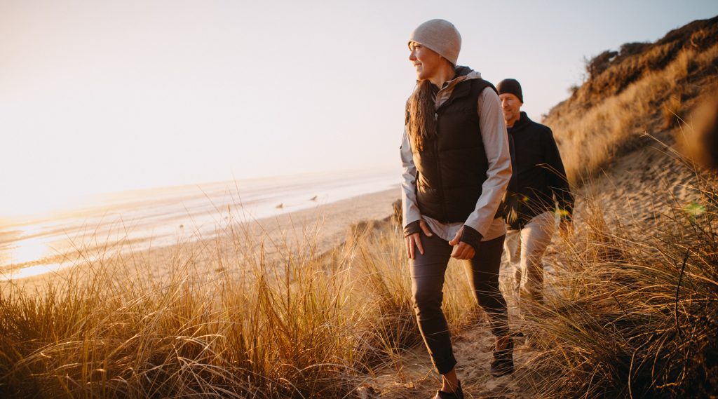 Couple hiking beach trail